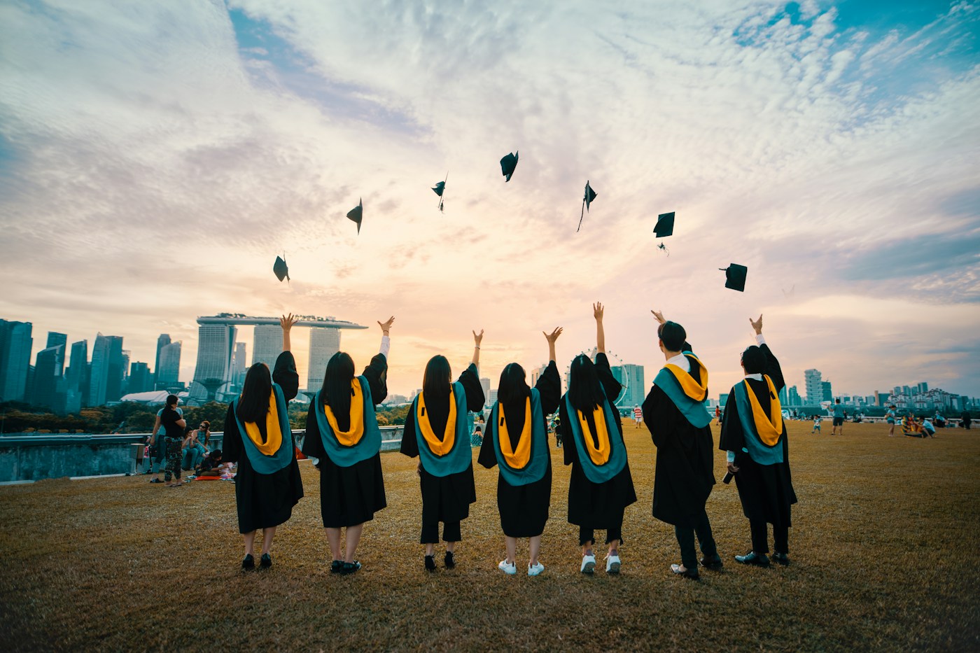 Graduates celebrating together at sunset